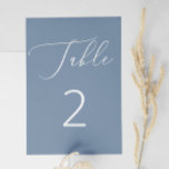 Klassische Nautical Dusty Blue Slate Script Weddin Tischnummer<br><div class="desc">Fügen Sie Ihrem Hochzeitsempfang eine beruhigende, raffinierte Touch mit dieser eleganten, staubblauen Tischnummer. Der coole Hintergrund und die weiße Schrift schaffen ein weiches, minimalistisches Aussehen, das sich perfekt für Hochzeiten im Frühjahr, Sommer oder an der Küste eignet. Inspiriert von scheußlichen Ufern und Meeresfarben, funktioniert dieses Design wunderbar für Strandfeiern, Empfänge...</div>