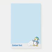 Kleiner Pinguin mit Schneeballschuhen, der nach de Post-it Klebezettel (Vorderseite)