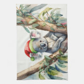 Koala-Weihnachtsmannmütze sitzt in einem Gummibaum Geschirrtuch (Vertikal)