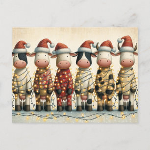 Kühe mit Weihnachtslicht der Weihnachtsmannmütze Feiertagspostkarte