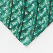 Künstliche geflochtene grüne Stofftextur. Fleecedecke (Ecke)