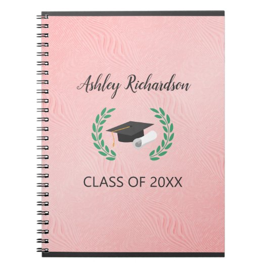 Laurel und Cap im rosa Hintergrund Notizblock (Vorderseite)