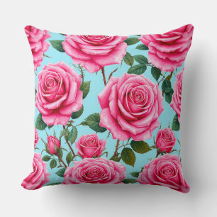 Lebendige rosa Rosen gemustert gegen Kissen