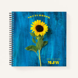 Lebhafte Sonnenblume und Monogramm auf blauem Hint Notizblock