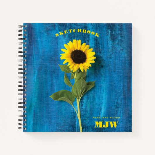 Lebhafte Sonnenblume und Monogramm auf blauem Hint Notizblock (Vorderseite)