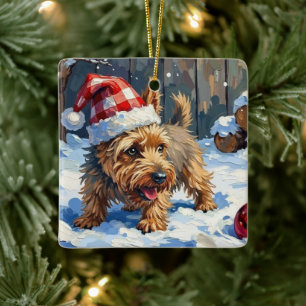 Lebhafter Cairn Terrier Hund gräbt nach Weihnachte Keramikornament