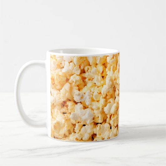Leckeres Popcorn auf dem ganzen Hintergrund. Essen Kaffeetasse (Links)