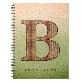 Letter-B-Holzkorn auf grünem beigem Grunge Notizblock