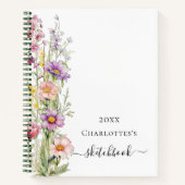 Lila gelbe Wildblumen in pinkfarbenem Sketchbuch Notizblock (Vorderseite)