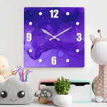 Lila Wasserfarbe Abstrakt mit Gold Glitzer Stars Quadratische Wanduhr<br><div class="desc">Winzige goldene Sterne blinken auf einem lila und dunkelblauen abstrakten Aquarellhintergrund. Entspannen Sie in Ihrem Lieblingssaal mit dieser atemberaubenden, dynamischen Wanduhr. Ihre Wahl einer rund oder quadratisch gedrehten Uhr. Macht ein großartiges Geschenk für die Hauswärmung! Sie können diese Wanduhr leicht personalisieren. Bitte schicken Sie mir eine Nachricht mit Fragen oder...</div>