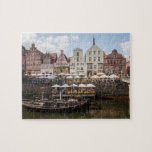 Lüneburg Puzzle<br><div class="desc">Ein Foto des Hafens mit Fluss Ilmenau und morgens Stintmarkt, Lüneburg, Niedersachsen, Deutschland wird auf diesem Puzzlen gekennzeichnet. Sie können von entweder 8" wählen Stückpuzzlespiel x 10" 110, oder 11" x 14" 252 bessern Puzzlen aus. Beide Größen kommen in schönen Geschenkboxen mit dem Bild, das auf dem Deckel gedruckt wird....</div>