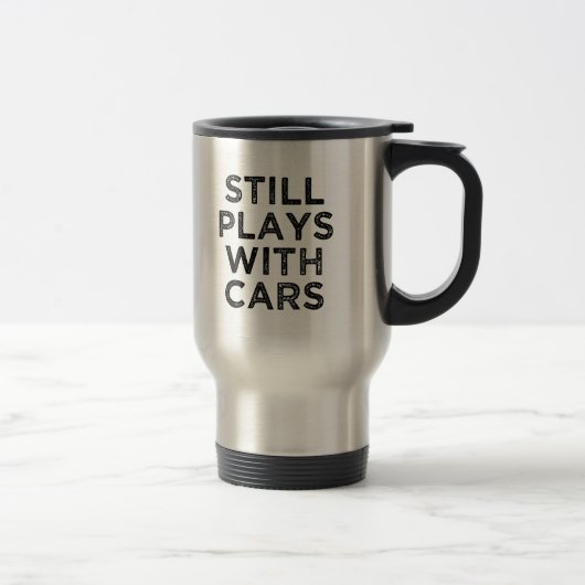 Lustig spielt noch mit der Kaffee-Tasse der Reisebecher (Rechts)