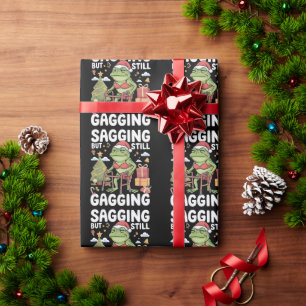 Lustige sarkastische Weihnachten hängend, aber imm Geschenkpapier
