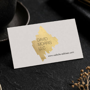 Luxus-Abstraktes Gold-Pinselstrich-Logo auf Beige Visitenkarte