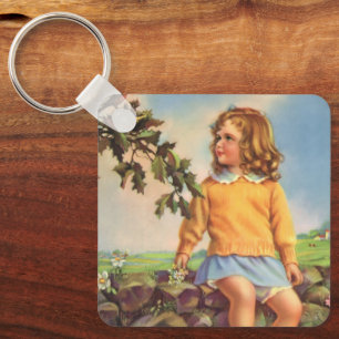 Mädchen im Vintage-Stil beobachtet Vögel in einem Schlüsselanhänger