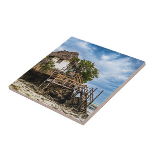 Malerisches Haus auf einem tropischen Korallenriff Fliese