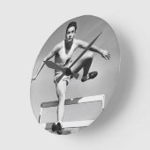 Man Hurdling Runde Wanduhr (Winkel)