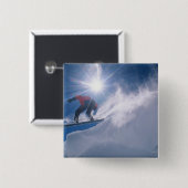 Man springt von einer großen Ecke auf einem Snowbo Button (Vorne & Hinten)