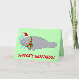 Manatee in Weihnachtsmannmütze und Scarf-Grüße der Feiertagskarte