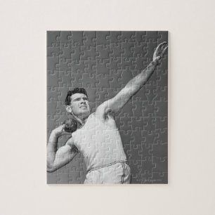 Mann, der Shotput wirft Puzzle