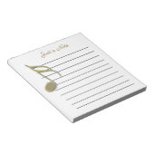 Metallische Gold-Musiknote auf Papierpad Notizblock (angewinkelt)