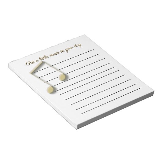 Metallische Gold-Musiknoten auf der Pad Notizblock (angewinkelt)