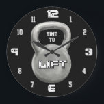 Minimalist Fitness Motivation Große Wanduhr<br><div class="desc">This bold Time to Lift wall clock features a powerful kettlebell design on a sleek black background, creating a strong and modern gym aesthetic. The minimalist style makes it a perfect addition to any home gym, workout room, or fitness studio. The large kettlebell centerpiece with the motivational phrase “Time to...</div>