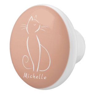 Minimalistische weiße Katze auf rosa Keramik hinz Keramikknauf