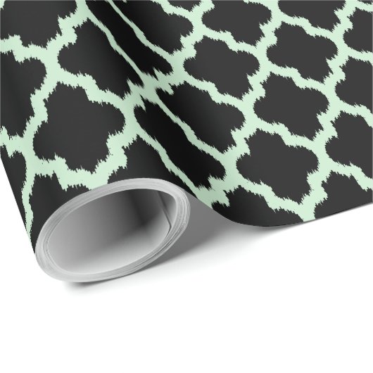 Mint-grüner Ikat-Quatrefolie über schwarzem Hinter Geschenkpapier (Rolleneckpunkt)