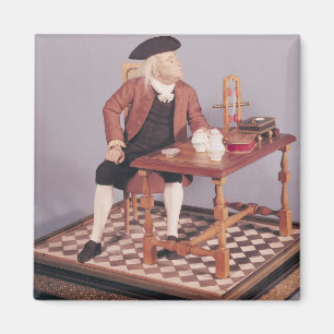 Modell von Benjamin Franklin an seinem Tisch Magnet