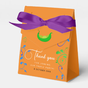 Moderne Erbsen in einer orangefarbenen Drillingspa Geschenkschachtel