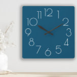 Moderne Minimalistische blaue Uhr<br><div class="desc">Fügen Sie Ihren eigenen Text (oder verlass ihn so wie er ist) zu dieser modernen minimalistisch marinalblauen und weißen Wanduhr hinzu.  Die Hintergrundfarbe ist mit dem Designwerkzeug von Zazzle vollständig anpassbar.</div>