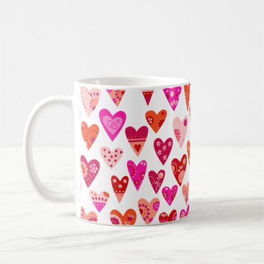 Moderne, rosafarbene Herzmuster Kaffeetasse (Links)