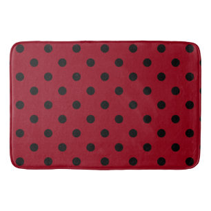 Moderne schwarze Tupfen auf Rot Badematte