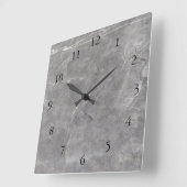 Moderne Uhr an der Wand aus grauem weißem Stein (Winkel)