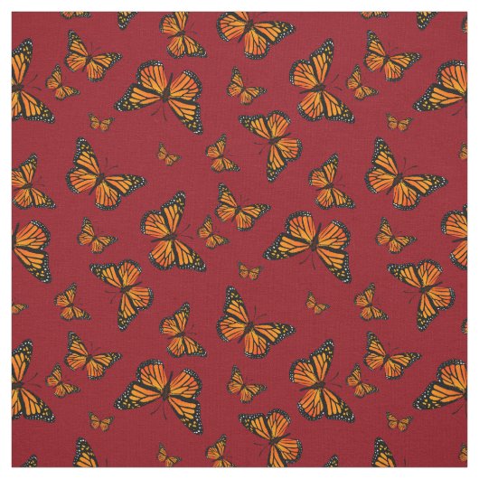 Monarch Butterfly-Muster auf dunkelrotem Hintergru Stoff (Muster)