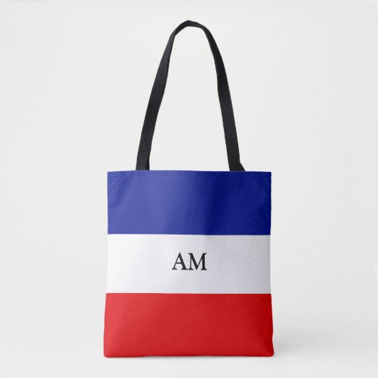 Monogramm auf der blau-rot-weiß gestreiften Totbeu Tasche (Vorderseite)