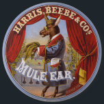 Mule Oar Tobacco Label Button<br><div class="desc">Tabaketikett,  auf dem ein auf den Hinterbeinen stehendes Maultier in voller Länge dargestellt wird,  das Kleid und die Brille trägt und Tabak-Blätter trägt. Harris,  Beebe & Cos.,  erstellt von The Hatch Lithography Co.,  1868</div>