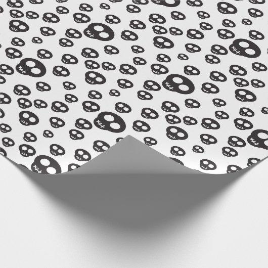 Muster mit schwarzen Schädeln auf weiß Geschenkpapier (Ecke)