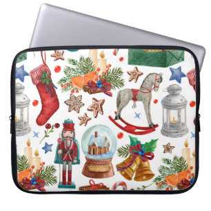 Muster mit Weihnachtsschmuck, Spielzeug und Laptopschutzhülle