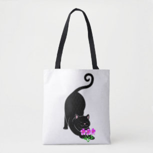 Nach unten gerichtete schwarze Kätzchenkatze und r Tasche