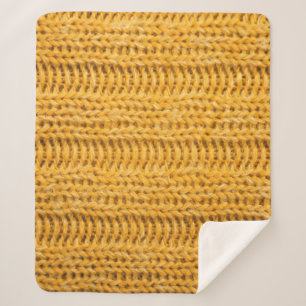 Nah aus gelbem gestricktem Hintergrund. Tr Sherpadecke