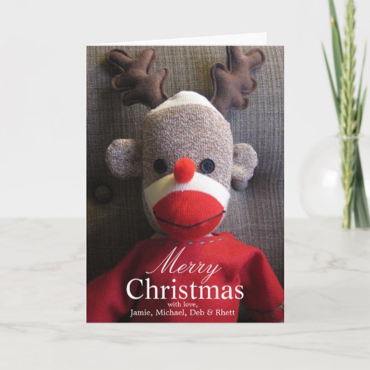 Nahaufnahme des Sockenaffegesichtes mit den Feiertagskarte (Vorderseite)