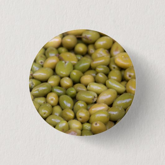 Nahes Aufsetzen grüner Oliven Button (Vorderseite)