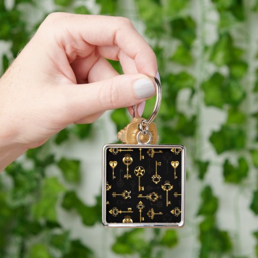 Nahtloses Muster mit Golden Keys Schlüsselanhänger (Hand)