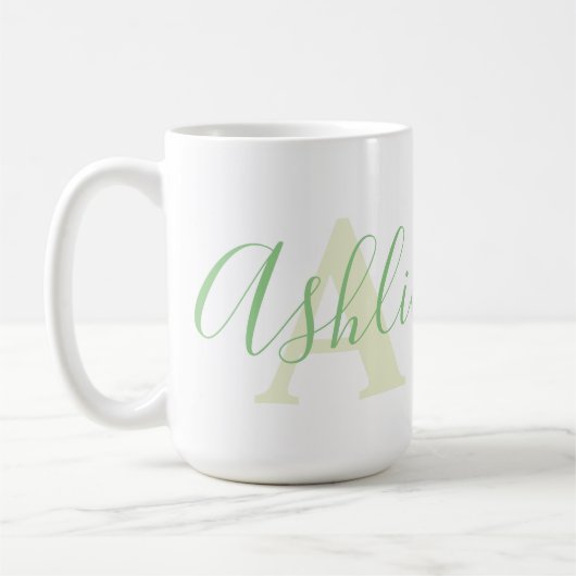 Name Ashlie Bedeutung und Monogramm Ein grüner Tex Kaffeetasse (Links)