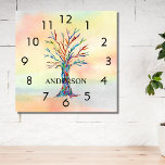 Name Monogram Rainbow Tree Square Wall Clock Quadratische Wanduhr<br><div class="desc">Diese farbenfrohe Wall Clock ist mit einem Mosaikbaum in den Farben des Regenbogens auf einem Aquarellboden dekoriert. Einfach mit Ihrem Namen oder Monogramm anpassbar. Weil wir unsere eigenen Kunstwerke erstellen,  werden Sie dieses exakte Bild von anderen Designern nicht finden. Original Mosaik und Wasserfarbe © Michele Davies.</div>