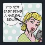 Natürliche Schönheit Comic Buchmauer Uhr<br><div class="desc">Diese skurrile Wanduhr bringt bestimmt ein Lächeln in die Lippen. Die "Natural Beauty Comic Book Wall Clock" zeigt eine hübsche junge Frau, die einen roten Lippenstift und eine Sprechblase verwendet, in der steht: "Es ist nicht einfach, eine natürliche Schönheit zu sein." Das Mädchen und die Sprechblase sind auf einem robinfarbenen,...</div>