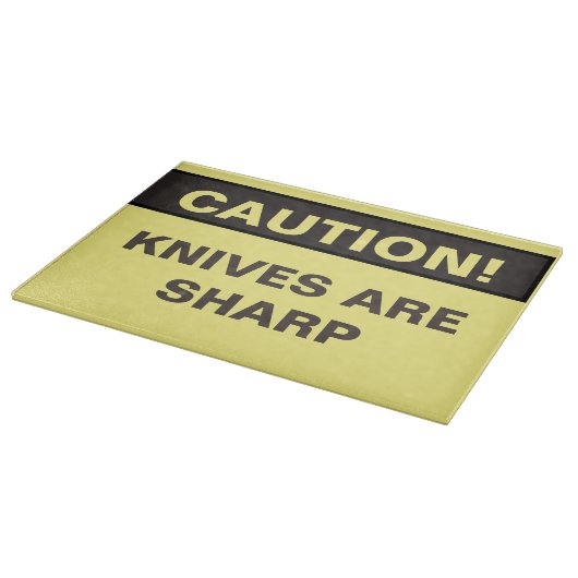 Neuheits-Vorsicht. Messer sind scharf Schneidebrett (Ecke)