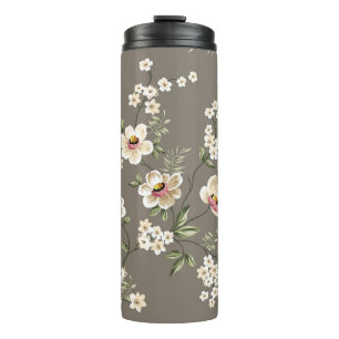 niedliche Creme-Blume mit grünen Blätter auf br Thermosbecher